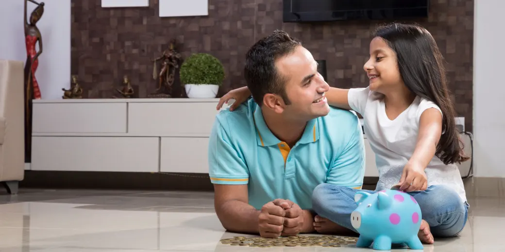 Dad and daughter playing and laughing outdoors