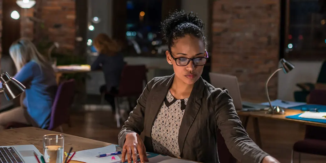 Woman working in darkened office