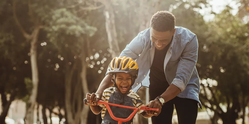 Man teaching boy to ride a bikie