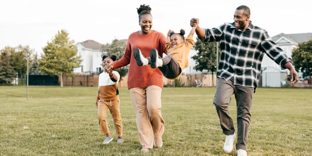 Family of four walking outdoors having fun