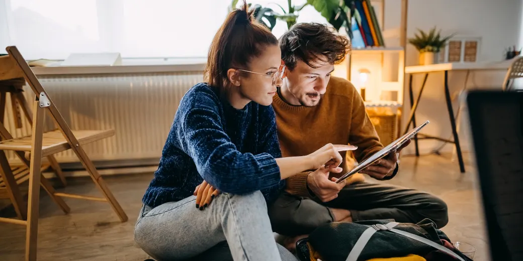 Young couple indoors discussing a document